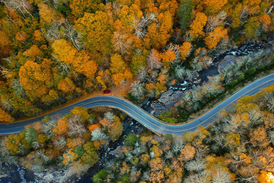 Charlotte, NC - Aerial View of Curved Road and Fall Trees in Blue Ridge Appalachian Mountains of North Carolina